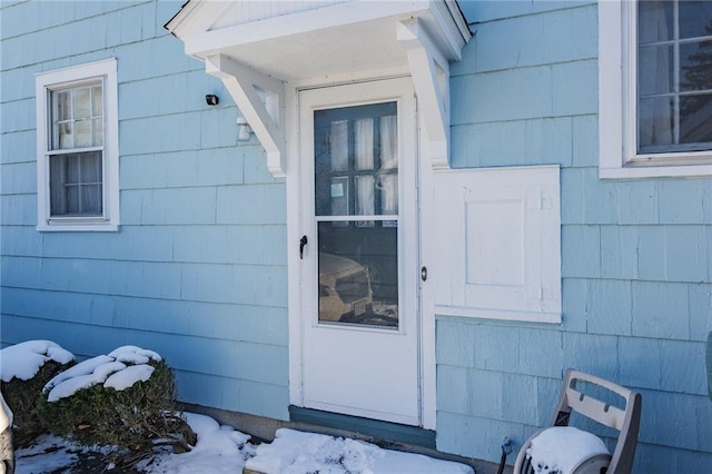 view of snow covered property entrance