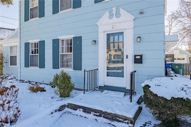 view of snow covered property entrance