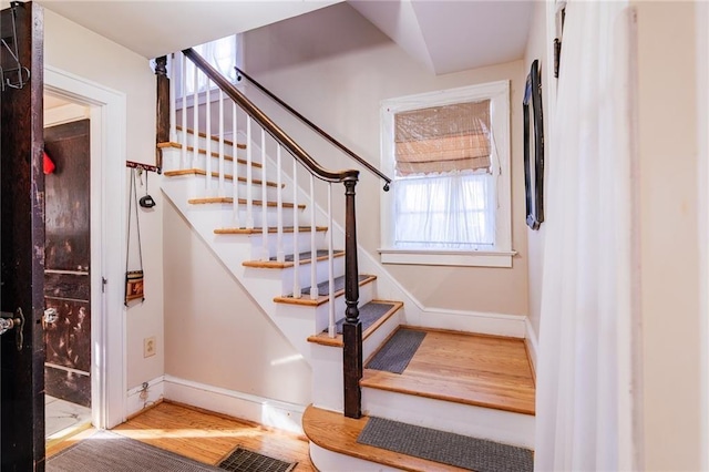 stairs with hardwood / wood-style floors