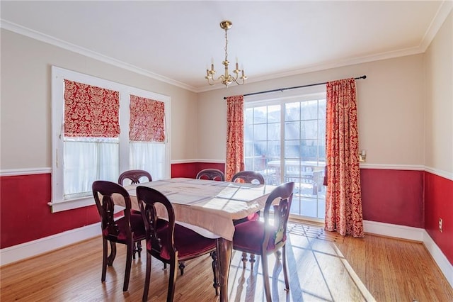 dining room with plenty of natural light, wood-type flooring, and ornamental molding