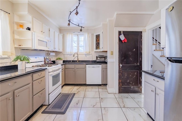 kitchen with tasteful backsplash, white appliances, sink, and ornamental molding