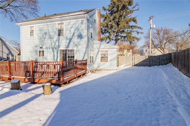 snow covered property with a deck