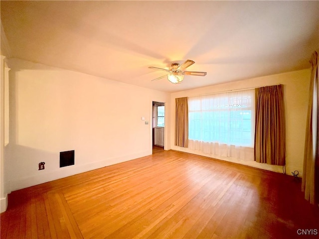 spare room featuring ceiling fan and hardwood / wood-style floors