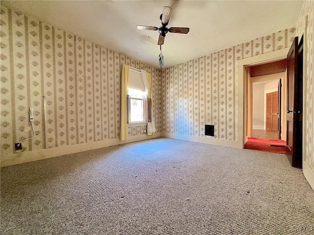 interior space with carpet floors and ceiling fan