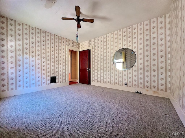 spare room featuring ceiling fan and carpet floors