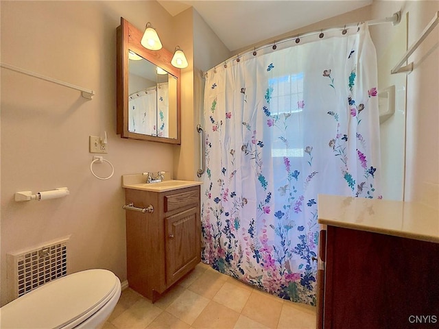 bathroom featuring tile patterned floors, vanity, toilet, and walk in shower