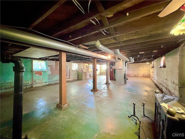 basement featuring separate washer and dryer and heating unit