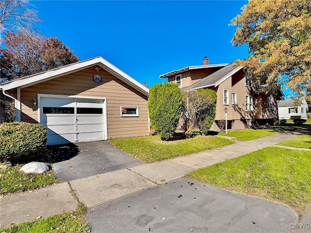 view of property exterior featuring a lawn and a garage