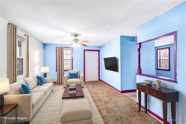 carpeted living room with ceiling fan