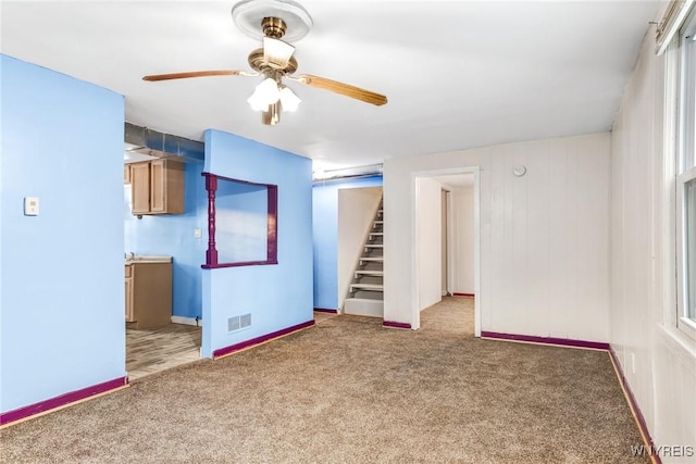 empty room featuring ceiling fan and carpet floors