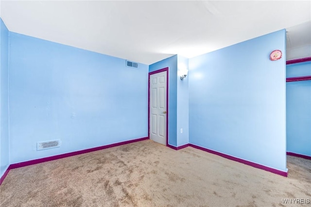 unfurnished room with light colored carpet