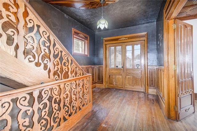 entryway featuring dark wood-type flooring and french doors