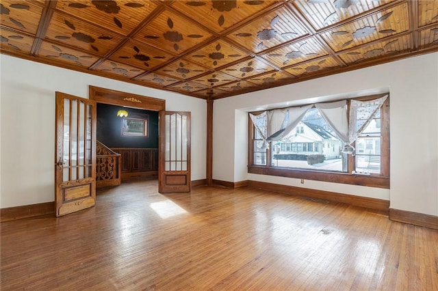 unfurnished living room featuring hardwood / wood-style floors, wooden ceiling, and coffered ceiling