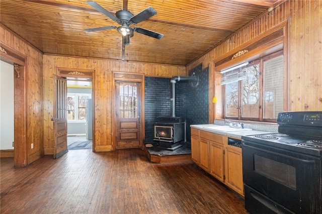 kitchen with a wood stove, wooden ceiling, sink, electric range, and ceiling fan