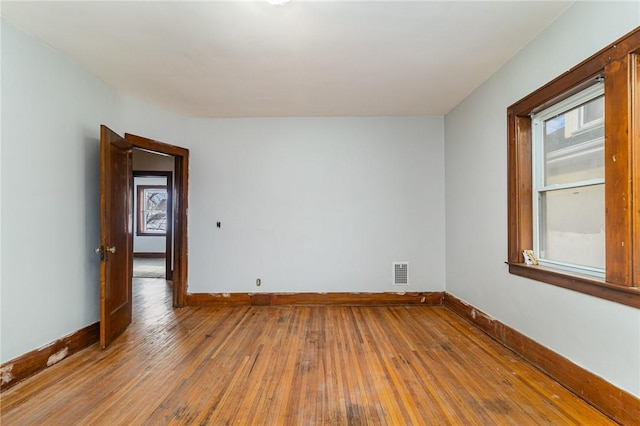 unfurnished room with hardwood / wood-style flooring