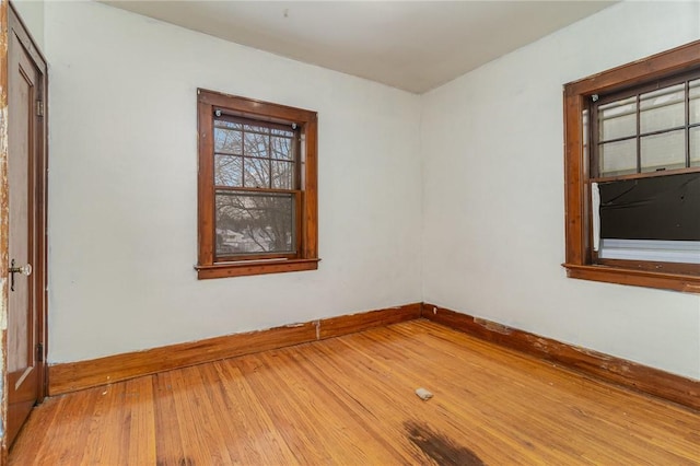 unfurnished room with hardwood / wood-style floors