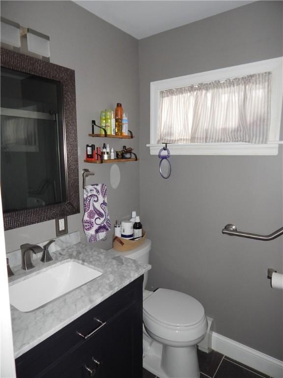 bathroom featuring tile patterned floors, vanity, and toilet