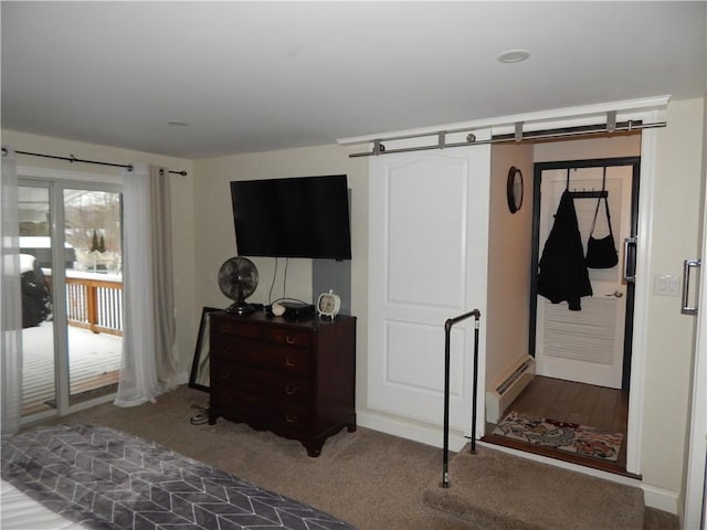 bedroom with access to outside, a barn door, carpet floors, and a baseboard heating unit