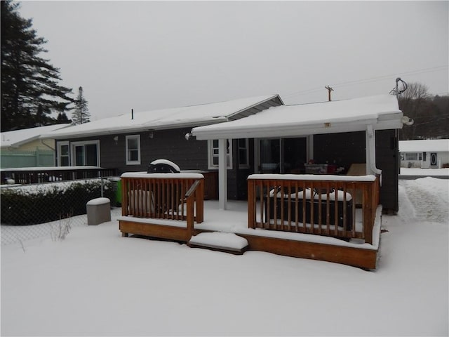 view of snow covered back of property