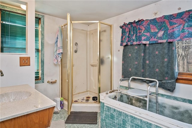 bathroom featuring separate shower and tub and vanity