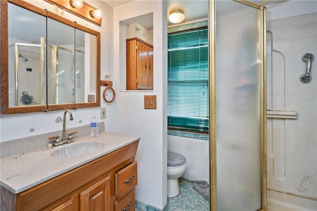 bathroom with vanity, toilet, and an enclosed shower