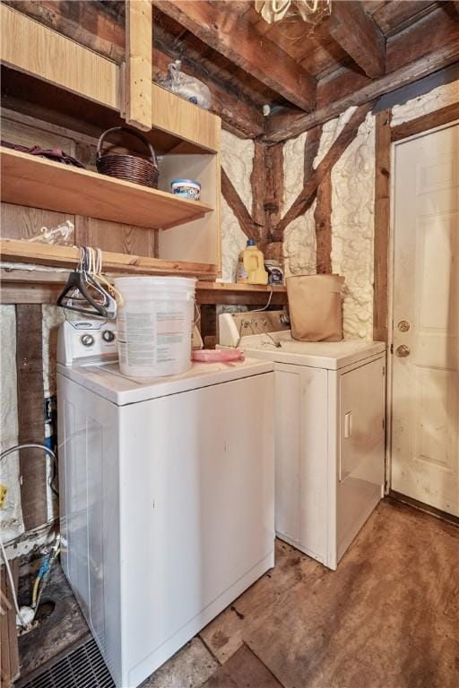 clothes washing area with washing machine and dryer