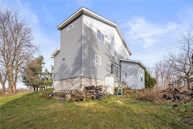 view of property exterior with a yard