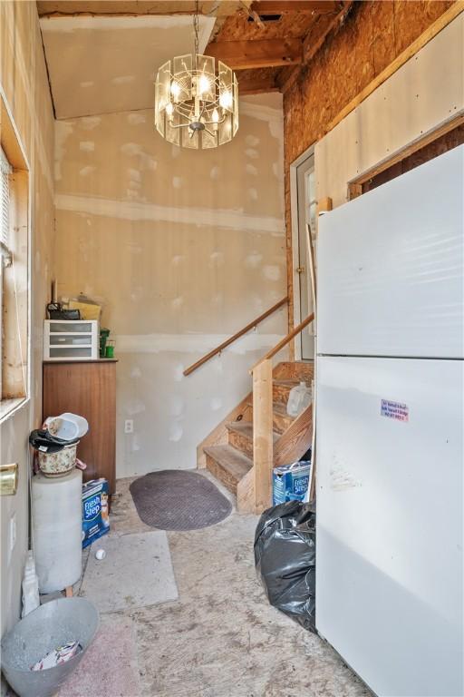 interior space with decorative light fixtures and white refrigerator