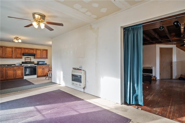 kitchen featuring white gas range, ceiling fan, heating unit, and light hardwood / wood-style floors