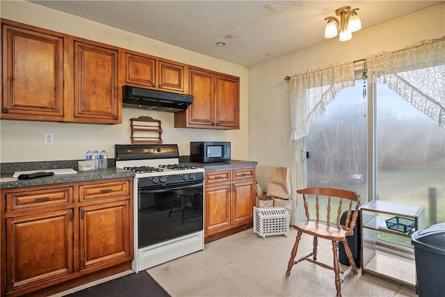 kitchen featuring gas range gas stove and a notable chandelier