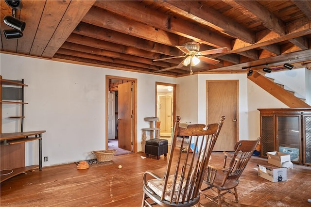 living area featuring beamed ceiling, wood-type flooring, and wooden ceiling