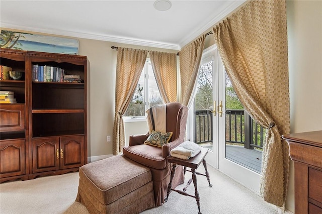 sitting room with french doors, light colored carpet, and ornamental molding