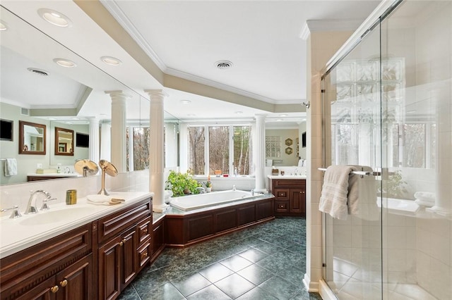 bathroom with plus walk in shower, vanity, decorative columns, and ornamental molding