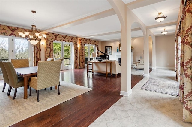 dining space featuring ornamental molding, light wood-type flooring, and a notable chandelier