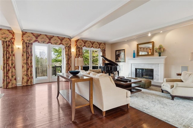 living room featuring dark hardwood / wood-style flooring, a high end fireplace, beamed ceiling, and ornamental molding