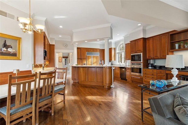 kitchen featuring an inviting chandelier, hanging light fixtures, built in appliances, ornamental molding, and kitchen peninsula