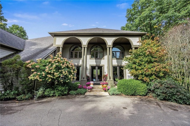 view of front facade with covered porch and french doors