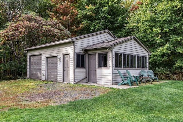 exterior space featuring a garage and a yard