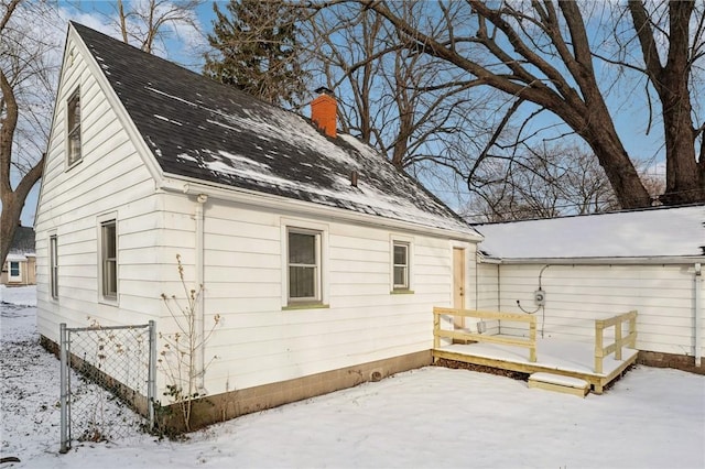 snow covered property featuring a deck