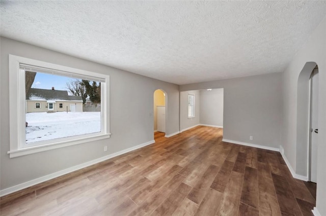 unfurnished room featuring hardwood / wood-style floors and a textured ceiling