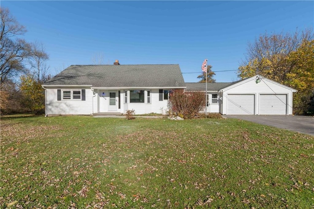 ranch-style home with a garage and a front yard