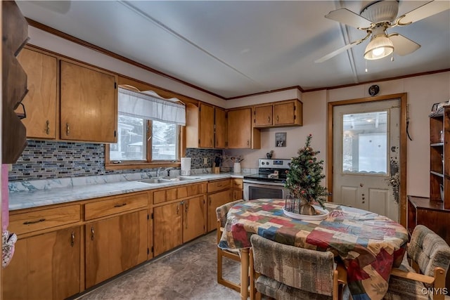 kitchen with stainless steel range with electric stovetop, sink, a wealth of natural light, and tasteful backsplash