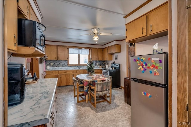 kitchen with backsplash, ceiling fan, and stainless steel appliances