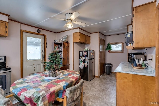 dining area featuring ceiling fan and crown molding