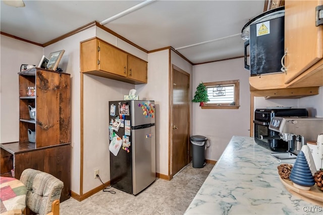 kitchen with stainless steel refrigerator and crown molding