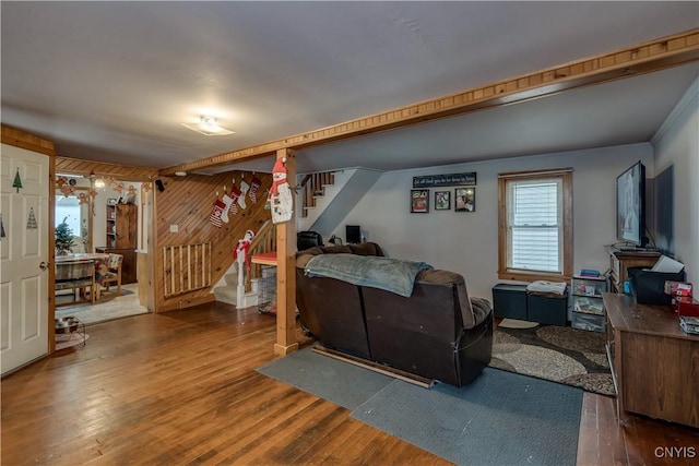 living room with hardwood / wood-style floors and wood walls