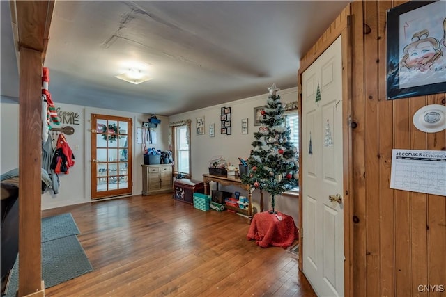 foyer featuring hardwood / wood-style flooring and wood walls