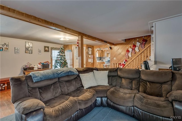 living room with wood walls and hardwood / wood-style flooring