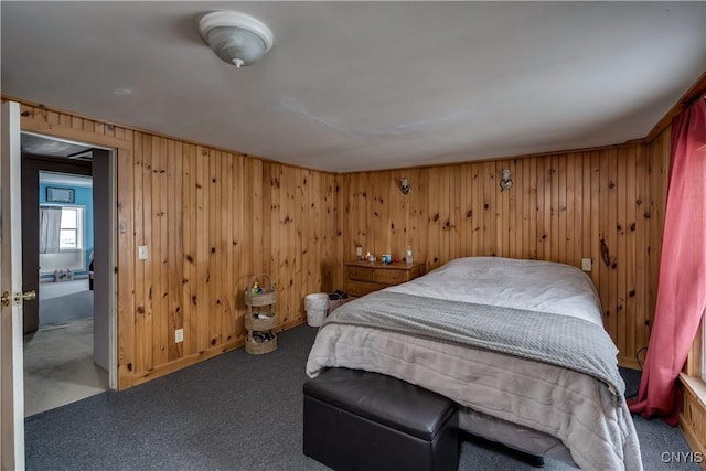 bedroom with wood walls and dark carpet