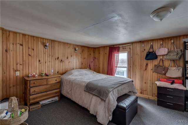 carpeted bedroom with wooden walls